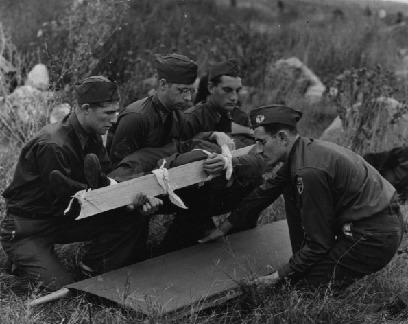 Medical Cadet Corps training on how to place an injured person on a stretcher