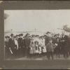 William Simpson with a group of baptismal candidates in front of an evangelistic tent