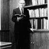 Andrews University president Richard L Hammill holding a book in his office