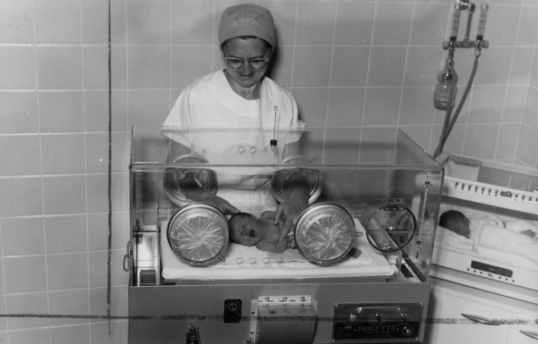 Hinsdale Sanitarium and Hospital maternity nurse caring for a newborn infant