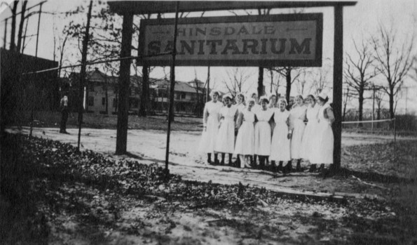 Hinsdale Sanitarium and Hospital nurses by the Hinsdale Sanitarium sign