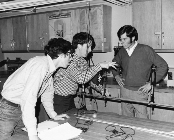 Southern Missionary College Physics professor Henry Kuhlman explains a principle to two students