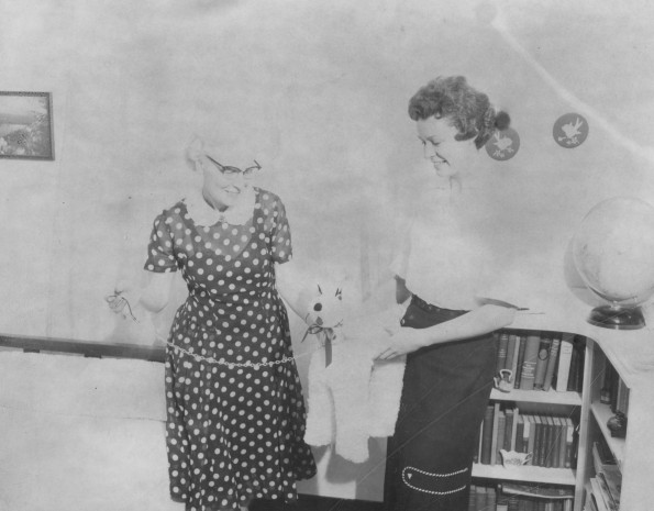 Andrews University assistant dean of women Mildred Rapson Martin recieves a toy dog gift