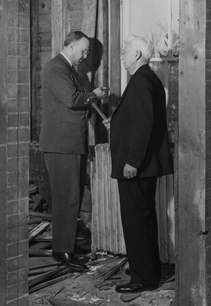 Emmanuel Missionary College president Percy Willis Christian and Sherman E Wight take a hand in wrecking the one-time main college building