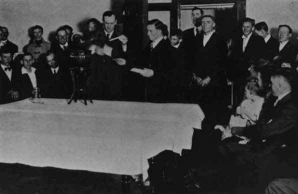 Otto Julius Graf holds a candle at the ceremonial burning of retiring a debt at Emmanuel Missionary College.