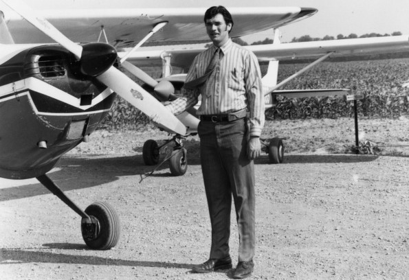 Andrews University flying student missionary Dan Wenberg in front of a plane