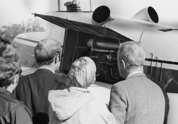 People observing a plane's engine on the day of Andrews University Advirsory Council Fly-in
