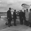 Five men greating a person who arrived at Andrews University Airport by plane