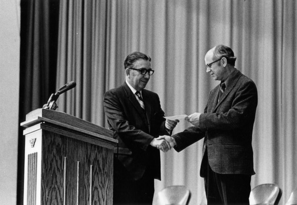 Warner E. McClure accepts a gift of appreciation from Andrews University president Richard  L. Hammill