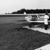 Two men inspecting the propeller of a plane at Andrews University Airport