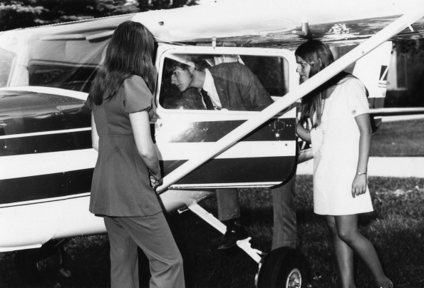 Penny Rusk, Liz Venden and Jud Nelson examins a plane landed on the athletic field and displayed in front of Alvin Johnson Auditorium during Andrews University registration day