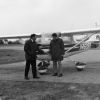 Two men in front of a plane at Andrews University Airport