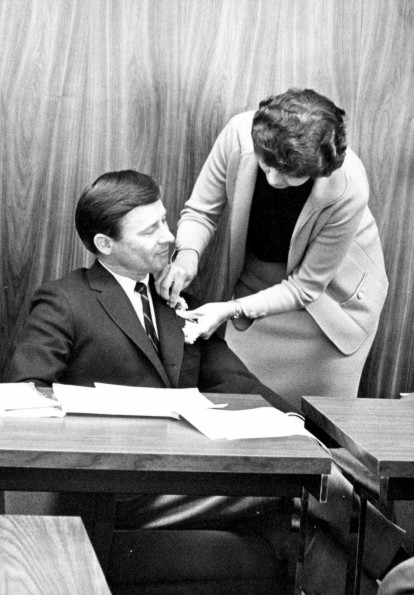 Andrews University board of trustees 1966-1967 member pinning on a boutonniere