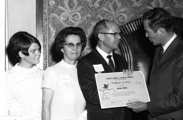 Andrews University president Richard L Hammill accepts his Volunteer Leadership Award from Governor William Milliken