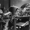 Two men working on a machine at Andrews University Airport aviation department