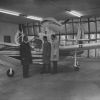Three man standing in front of a plane at the Andrews University Airport T-hangar