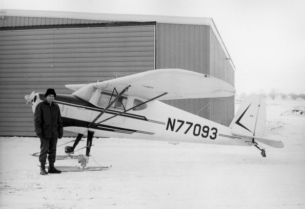 Wendell Cole stands beside the Cessna 140 teaching plane