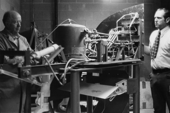 Two men working on a machine at Andrews University Airport aviation department