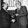 [Wesley Christiansen accepting a plaque from Richard Hammill during Andrews University's 1972 alumni homecoming]