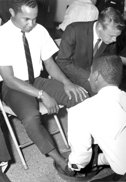 [Andrews University students take turns washing feet during communion service]