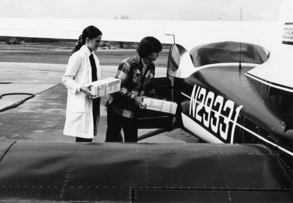 [Lois Miller and Terry Copsey loading blood samples into an airplane at the Andrews University Airport]