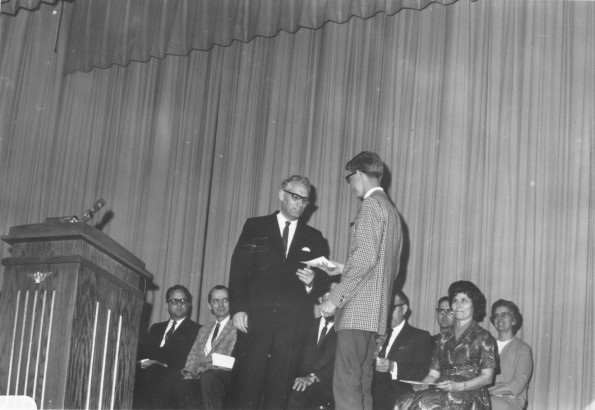 [Robert Firth presents the Wall Street Journal award to a student]