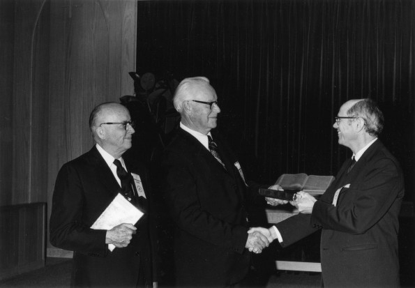 [Pastor Kenneth Wright receiving a copy of The Wisdom Seekers at Andrews University's 1973 alumni homecoming]