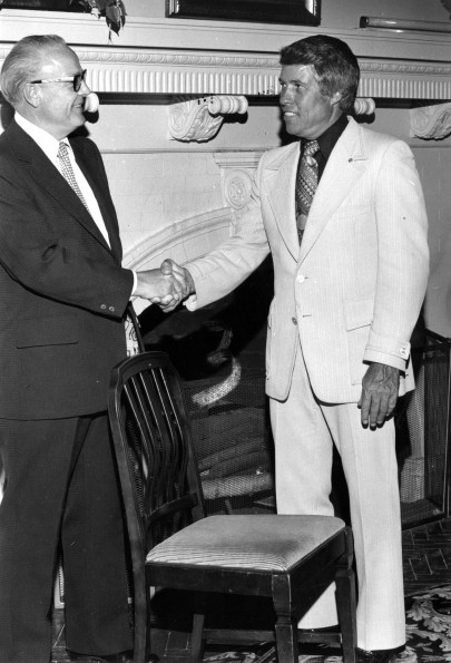 [H. H. Hill and Donald Prior with a chair designed by John Harvey Kellogg]