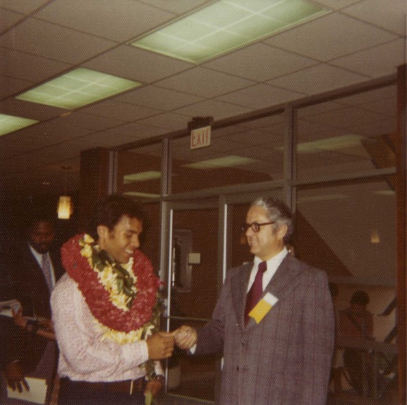 Andrews University Alumni Association president, Floyd Costerisan, welcomes graduate Paul Chung to the Alumni Association