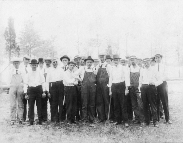 [Group of Seventh-day Adventist men setting up for a camp meeting]