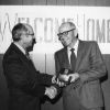 [Wesley Christiansen accepting a plaque from Richard Hammill during Andrews University's 1972 alumni homecoming]