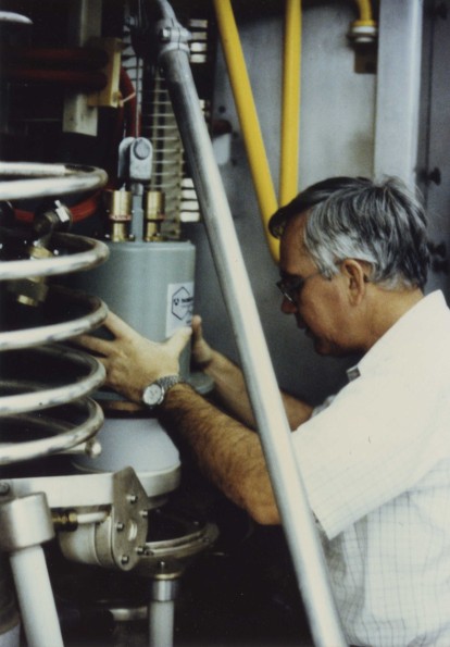 [Elvin Vence, chief engineer, installing a new tube in the transmitter]