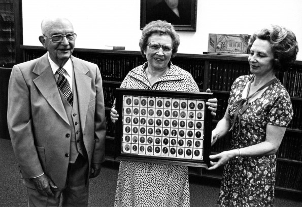[Emmett Vande Vere, Mary Jane Mitchell, and Louise Dederen with a new acquisition for the Andrews University Heritage Room]