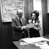 [Emmett Vande Vere and Louise Dederen reviewing historical pictures in the Heritage Room at Andrews University]