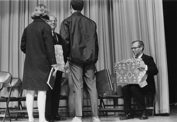 [C. Warren Becker talkes with two students following his recieving the Teacher of the Year award]