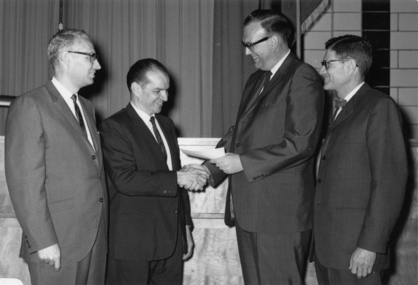 [Trickett presents awards to Andrews University graduate business administration students]