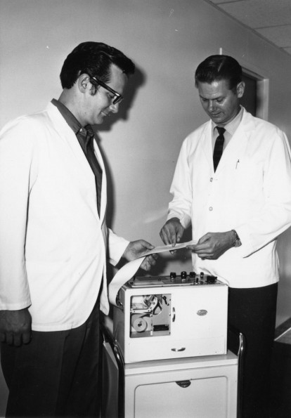 [K. Robert Lang and Herald Allen Habenicht, Jr. observing an electrocardiogram at Andrews University Medical Center]