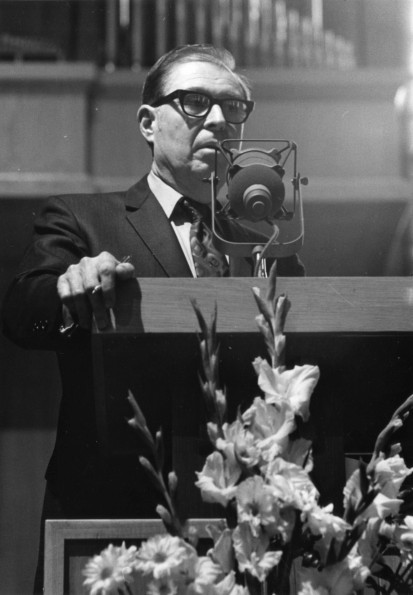 [James S. Barclay speaks to audience and panel at Andrews University's 1973 alumni homecoming]
