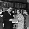 [Library staff holding the 300,000th accessioned book in the James White Library]
