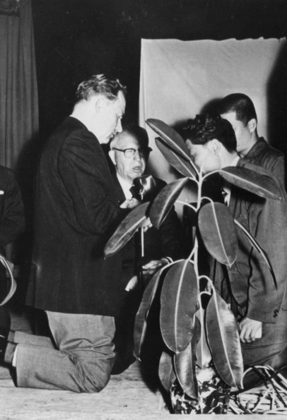 Andrews University graduate, Tate Van Eman Zytkoskee, conducts a prayer service for a Korean prisoner released for a week to attend a youth congress