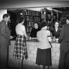 [Students at the circulation desk of Emmanuel Missionry College library]