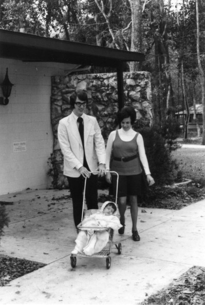 [Gene and Marie Jennings, members of the Christian band,  Ponder, Harp, and Collins,  who played at the 1972 Andrews University alumni retreat in Florida, are seen walking with their child asleep in the stroller.]