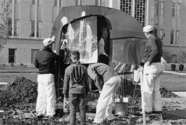 [Student portesters vandalize a sculpture in front of the administration building at Andrews University]