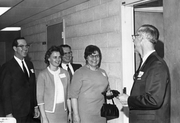 Andrews University alumni South-Western Michigan Chapter president Edwin Buck, gives complimentary tickets for a concert-lecture program