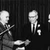 Andrews University alumnus of the year, Owen A. Blake, recieves a desk pen holder from alumni president, F. E. J. Harder, and Andrews University president, Richard L. Hammill