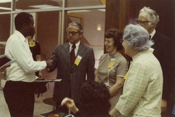[Floyd Costerisan, Elsie Landon Buck, and Horace J. Shaw welcoming new graduates to the Alumni Association]