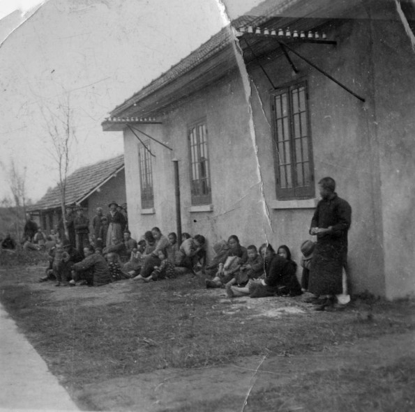 Chinese people sitting outside of the house