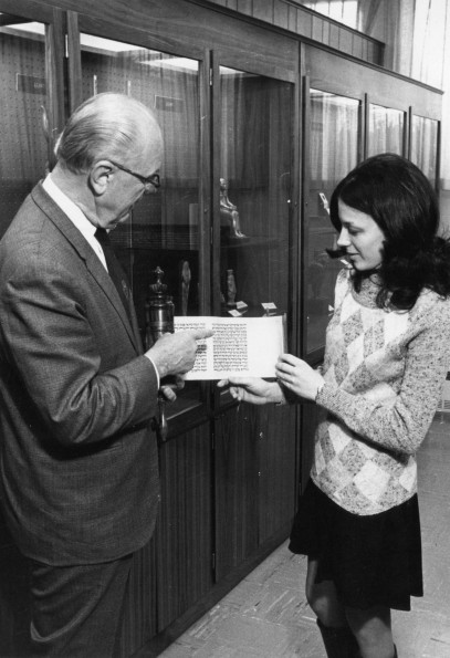 [Siegfried Horn showing Debbie Boyer the Esther scroll in the Andrews University Archaeological Museum]