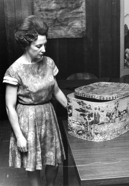 [Louise Dederen observing William Miller's hatbox in the Heritage Room in the James White Library]