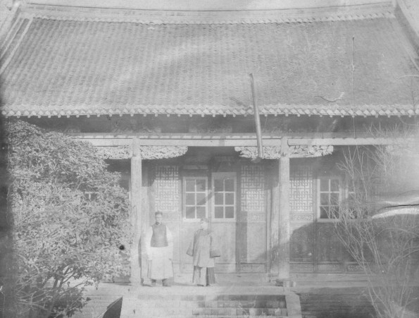 Chinese house with a man and women standing on the front porch